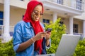 Beautiful young African woman smiling while using her laptop outside Royalty Free Stock Photo