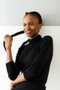 Beautiful young african woman touching her long hair on studio background Royalty Free Stock Photo