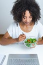 Beautiful young afro woman eating salad in office Royalty Free Stock Photo