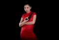 beautiful young Asia woman red dress traditional cheongsam holding gun at the black background Royalty Free Stock Photo