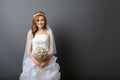 Beautiful young asian bride in wedding dress with flower bouquet Royalty Free Stock Photo