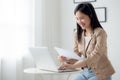 Beautiful young asian business woman using laptop computer working from home for video conference online. Royalty Free Stock Photo