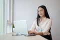 A beautiful young Asian businesswoman or female officer is working on her laptop in the office Royalty Free Stock Photo