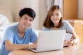 Beautiful young asian couple calculate expenses finance with laptop and planning together, woman writing notebook