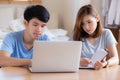 Beautiful young asian couple calculate expenses finance with laptop and planning together