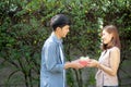 Beautiful young asian couple happy and smiling giving gift box together with romantic in valentine day