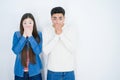Beautiful young asian couple over white isolated background shocked covering mouth with hands for mistake Royalty Free Stock Photo