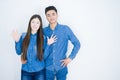 Beautiful young asian couple over white isolated background showing and pointing up with fingers number ten while smiling Royalty Free Stock Photo