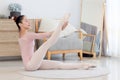 Beautiful young Asian female ballerina practicing ballet dance in the living room. Flexible ballet woman dancer doing stretching Royalty Free Stock Photo