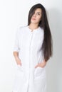 Beautiful young asian female doctor in medical gown holding a phonendoscope Royalty Free Stock Photo