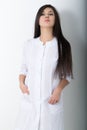 Beautiful young asian female doctor in medical gown holding a phonendoscope Royalty Free Stock Photo