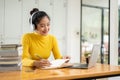 A beautiful young Asian female university student is studying an online class or lecture Royalty Free Stock Photo