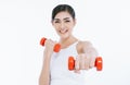 Beautiful young Asian fitness woman lifting dumbbells smiling and energetic isolated over white background. Healthy lifestyle