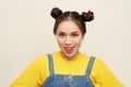 Beautiful young Asian girl wearing jeans dungaree with two buns hair on white background