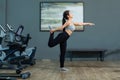 Beautiful young asian girl is wearing workout clothes and doing yoga exercises at the fitness center Royalty Free Stock Photo