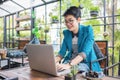 Beautiful young Asian girl working at a coffee shop with a laptop Royalty Free Stock Photo