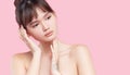 Beautiful young asian korean woman with clean fresh skin touching her own face. Face treatment. Royalty Free Stock Photo