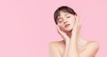 Beautiful young asian korean woman with clean fresh skin touching her own face. Face treatment. Royalty Free Stock Photo