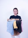 Beautiful young asian laundry holding clothing basket isolated on white background., Hold a laundry basket to wash Royalty Free Stock Photo