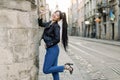 Beautiful young Asian model woman with ponytail hair, in fashionable casual black leather jacket and denim, and heels Royalty Free Stock Photo