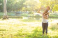 Beautiful young asian mother carrying little daughter with smile, child ride the neck on mom with happiness and cheerful