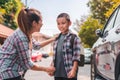 Beautiful young asian mother or parent helping son or pupil to getting in the car to ride to school, Selective focus, Back to Royalty Free Stock Photo