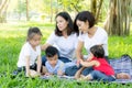 Beautiful young asian parent family portrait picnic in the park, kid or children and mother love happy and cheerful together Royalty Free Stock Photo