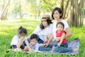 Beautiful young asian parent family portrait picnic in the park, kid or children and mother love happy and cheerful together Royalty Free Stock Photo