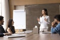 Beautiful young Asian project leader woman speaking to multiethnic team Royalty Free Stock Photo