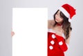 Beautiful young asian Santa woman holding blank board for xmas isolated on white background Royalty Free Stock Photo