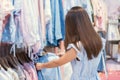 Beautiful young Asian woman in blue dress shopping fashion cloths in department store, blur background. Shopping concept Royalty Free Stock Photo