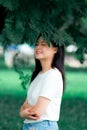 Beautiful young Asian woman Chinese is enjoy relaxing in green nature background portrait vertical