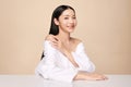 Beautiful young asian woman with clean fresh skin on beige background, Face care, Facial treatment, Cosmetology, beauty and spa,