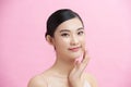 Beautiful Young Asian woman with clean fresh white skin touching her own face softly in beauty pose Royalty Free Stock Photo