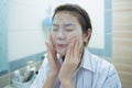 Face wash. Close up of young asian woman cleaning face skin with cleansing foam. Royalty Free Stock Photo