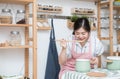 Beautiful young asian woman cooking and testing soup food in the kitchen, female cook food by herself in quarantine period,Social Royalty Free Stock Photo