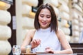 Beautiful young Asian woman with cup of coffee. Woman enjoys fresh coffee in the morning with sunrise at coffe shop Beautiful Royalty Free Stock Photo