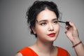 Beautiful young asian woman doing makeup using mascara on her eyelashes Royalty Free Stock Photo