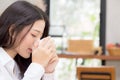 Beautiful young asian woman drinking coffee and smile in the morning at cafe, girl sitting in coffee shop for breakfast and leisur Royalty Free Stock Photo