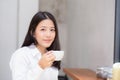 Beautiful young asian woman drinking coffee and smile in the morning at cafe Royalty Free Stock Photo