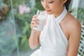 Beautiful young asian woman drinking fresh milk in the morning at home with happy face Royalty Free Stock Photo