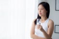 Beautiful young asian woman drinking glass of water mineral pure with fresh and happy at home. Royalty Free Stock Photo