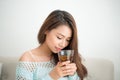 Beautiful young asian woman drinking her morning tea over a breakfast at home. Royalty Free Stock Photo