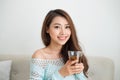 Beautiful young asian woman drinking her morning tea over a breakfast at home. Royalty Free Stock Photo