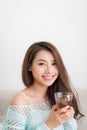Beautiful young asian woman drinking her morning tea over a breakfast at home. Royalty Free Stock Photo