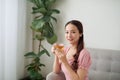 Beautiful young Asian woman drinking tea in the morning at living room Royalty Free Stock Photo