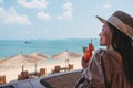 A beautiful young woman drinking watermelon juice while sitting in the beach cafe Royalty Free Stock Photo