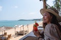 A beautiful young woman drinking watermelon juice while sitting in the beach cafe Royalty Free Stock Photo