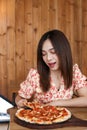 Beautiful Young asian woman eating delicious or yummy pizza Royalty Free Stock Photo