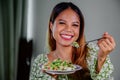 beautiful young asian woman eating healthy mediterranean food. smiling happy girl eating greek salad Royalty Free Stock Photo